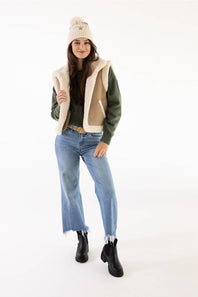 Model wearing a Carhartt thick knit cuffed beanie with a pom-pom in Oat Milk