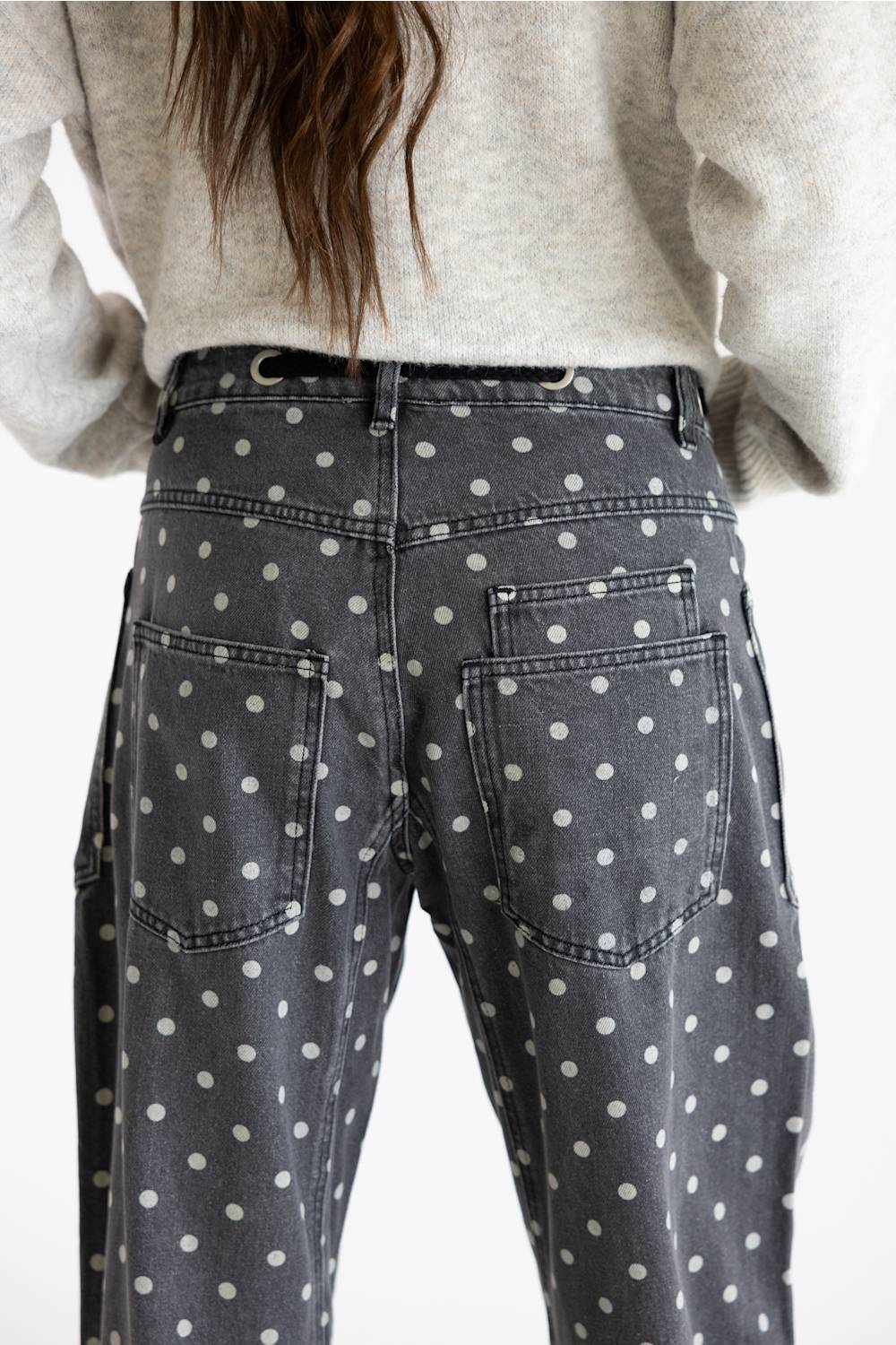 Close-up rear view of Aaron & Amber Drawstring Polka Dot Barrel Jeans in black highlighting the back waist, belt loops, and rear patch pockets.