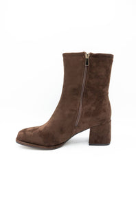 A brown suede ankle boot with a block heel and side zipper, shown from a side profile on a white background.