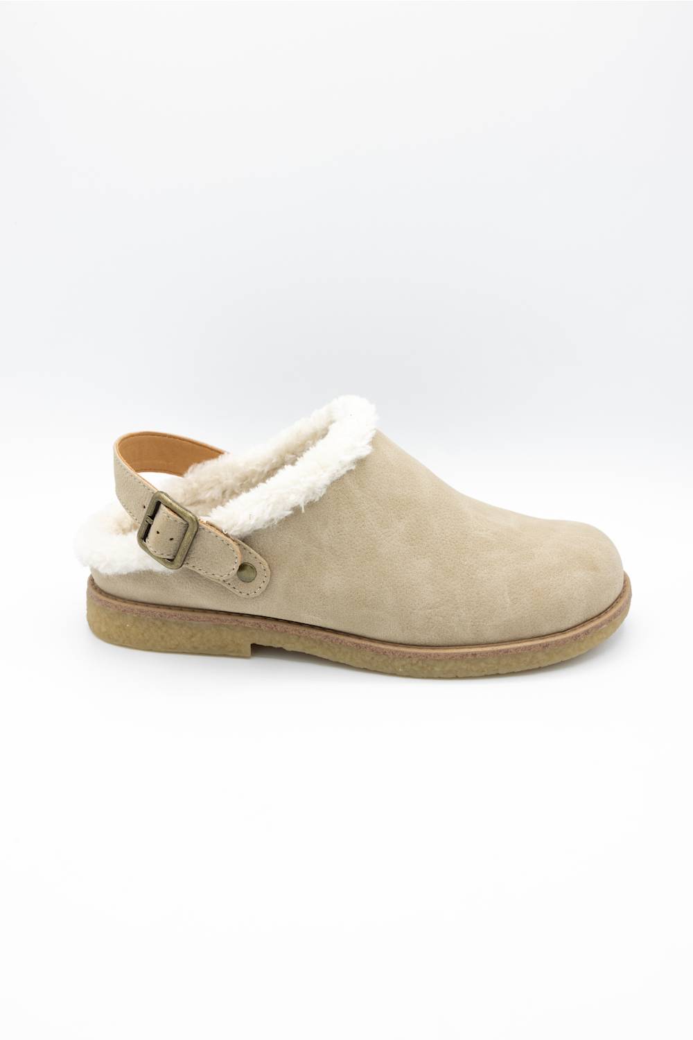 A single beige suede clog-style slipper with a white faux-shearling lining and a tan buckle strap, shown from the side on a white background.