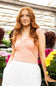 Ruched Tank Top for Women in Rose; Woman with long red hair standing in a greenhouse with flowers in the background