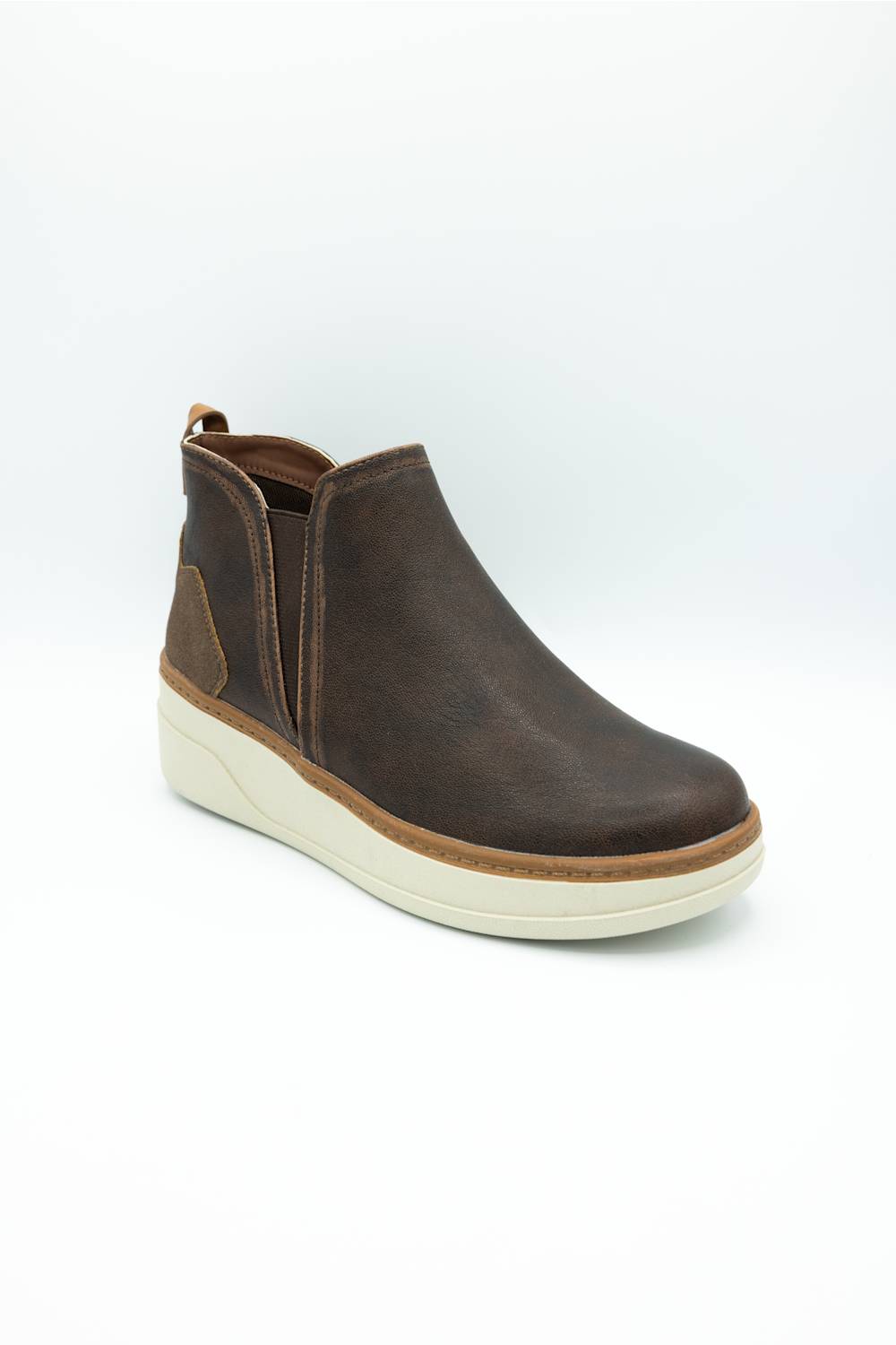 A dark brown leather Chelsea-style ankle boot with elastic side gore panels and a thick cream-colored wedge sole, shown on a white studio background.