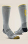 A pair of gray ribbed crew socks with yellow accents, including a yellow 'A-RIAT' logo on the side, a yellow toe cap, and a black heel, shown against a light beige background.