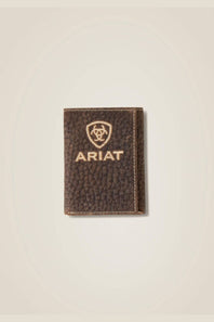 A dark brown textured leather card holder wallet with gold-toned stitching and an embossed Ariat shield logo and brand name on the front, set against a light beige background.