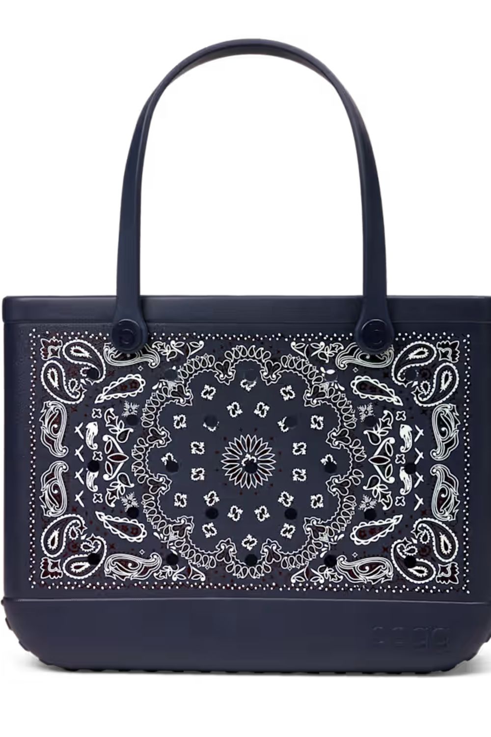 A navy blue tote bag featuring a large white paisley bandana print on the front panel and matching dark handles, shown against a plain white background.