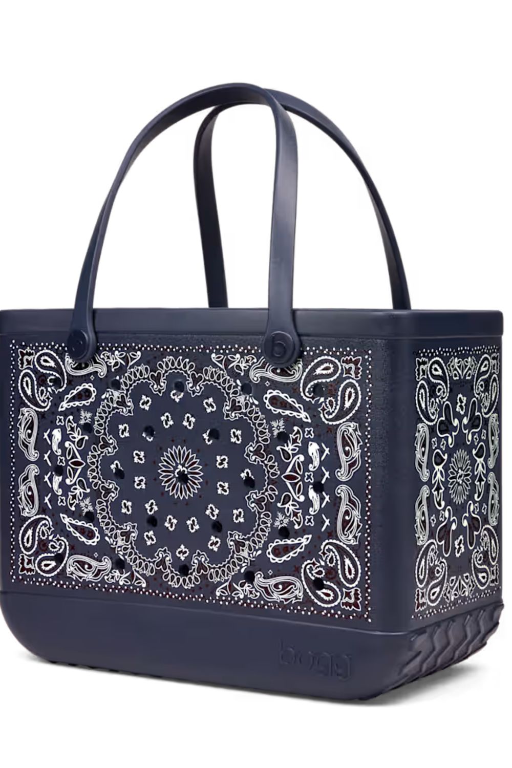 A navy blue tote bag featuring a white paisley bandana print on the front and sides, with matching dark handles and a quilted base.