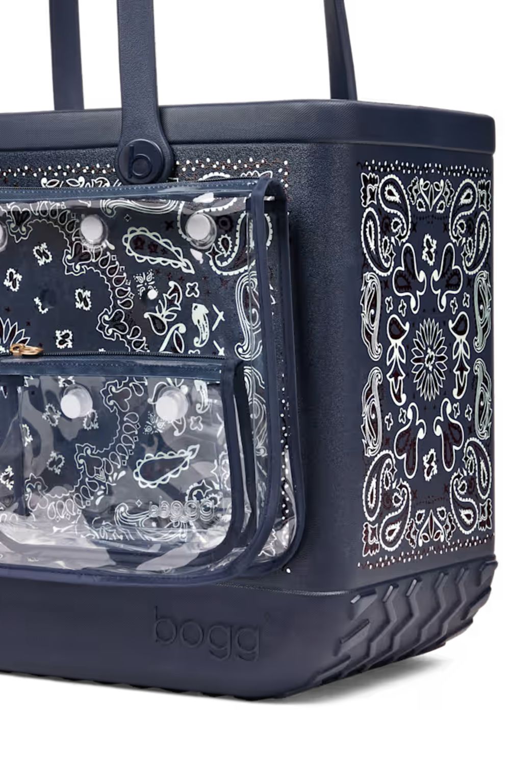 A navy blue Bogg brand picnic basket with a clear front pocket featuring a white paisley bandana print, set against a plain white background.