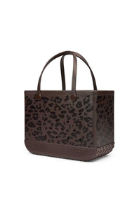 A dark brown leather tote bag with a black leopard print pattern, featuring dual top handles and a braided leather base, shown on a plain white background.