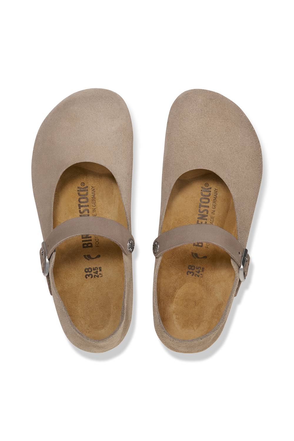 A single women's Mary Jane flat shoe in a light taupe suede-like material, featuring a wide strap with a silver-tone buckle and a black outsole, shown on a white background.