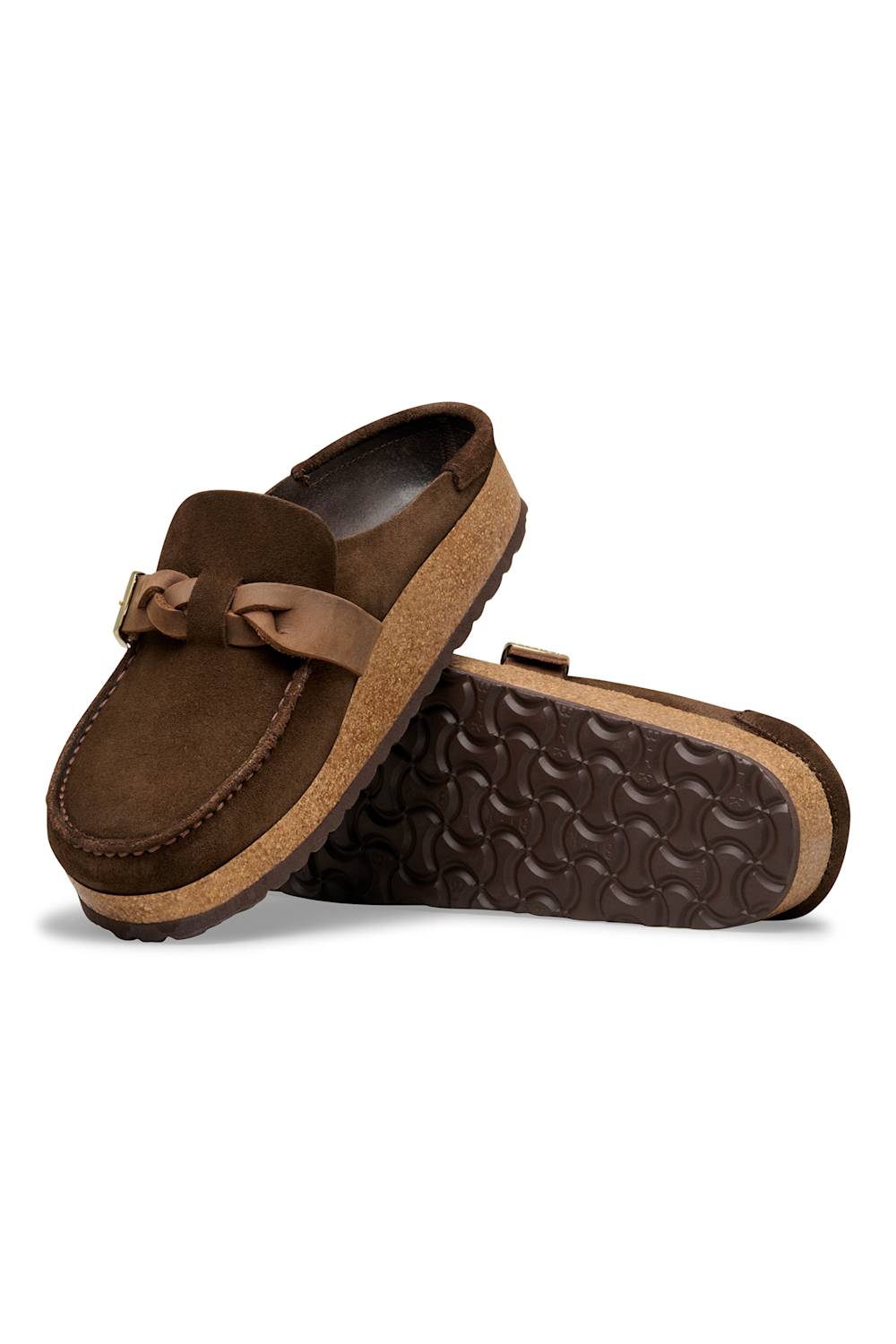 A pair of brown suede mule loafers with a tan leather strap detail and a textured brown sole, displayed on a clean white background.