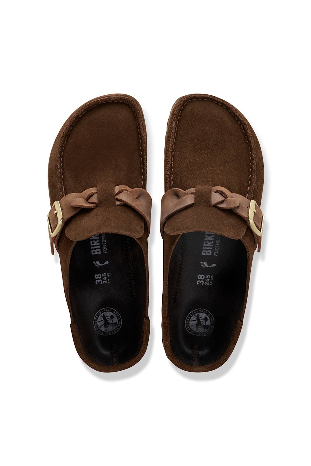A pair of brown suede mule sandals with a decorative bow detail and gold-tone buckle, shown from a top-down view on a white background.
