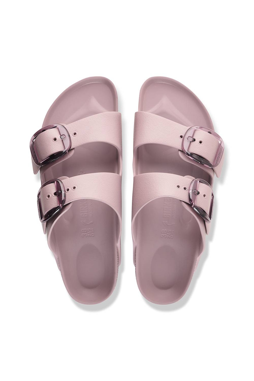 A pair of double-strap slide sandals in a dusty pink color, featuring adjustable metallic silver buckles, shown from a top-down view on a white background.