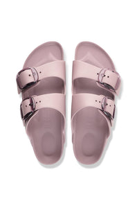 A pair of double-strap slide sandals in a dusty pink color, featuring adjustable metallic silver buckles, shown from a top-down view on a white background.