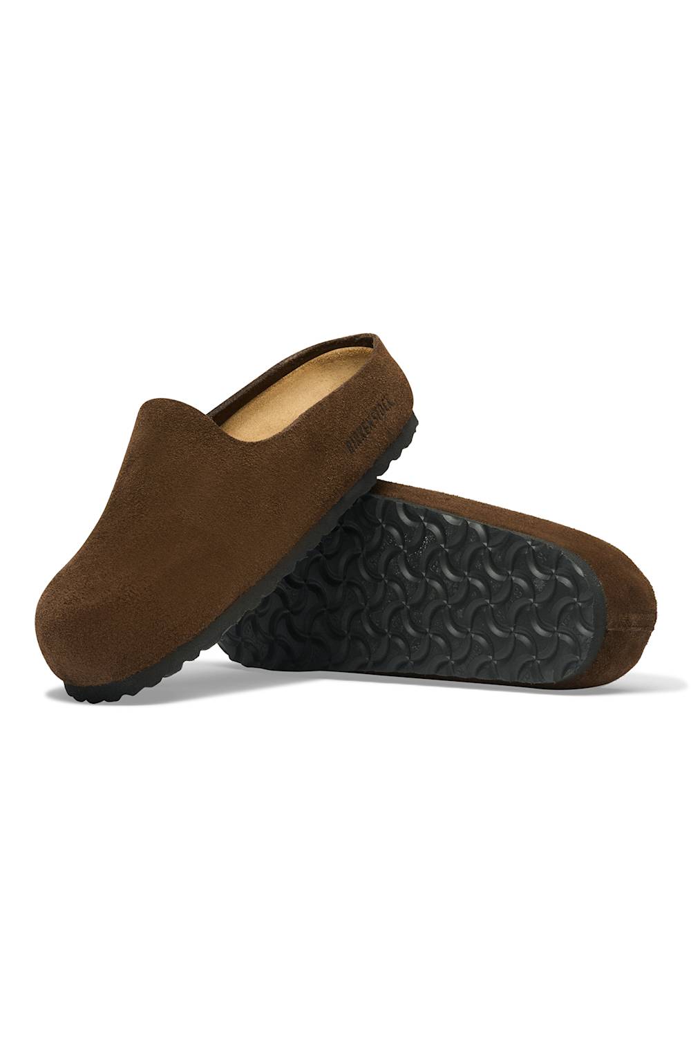 A pair of brown suede slip-on clogs shown on a clean white background, with one shoe standing upright and the other lying on its side to display the textured black outsole.