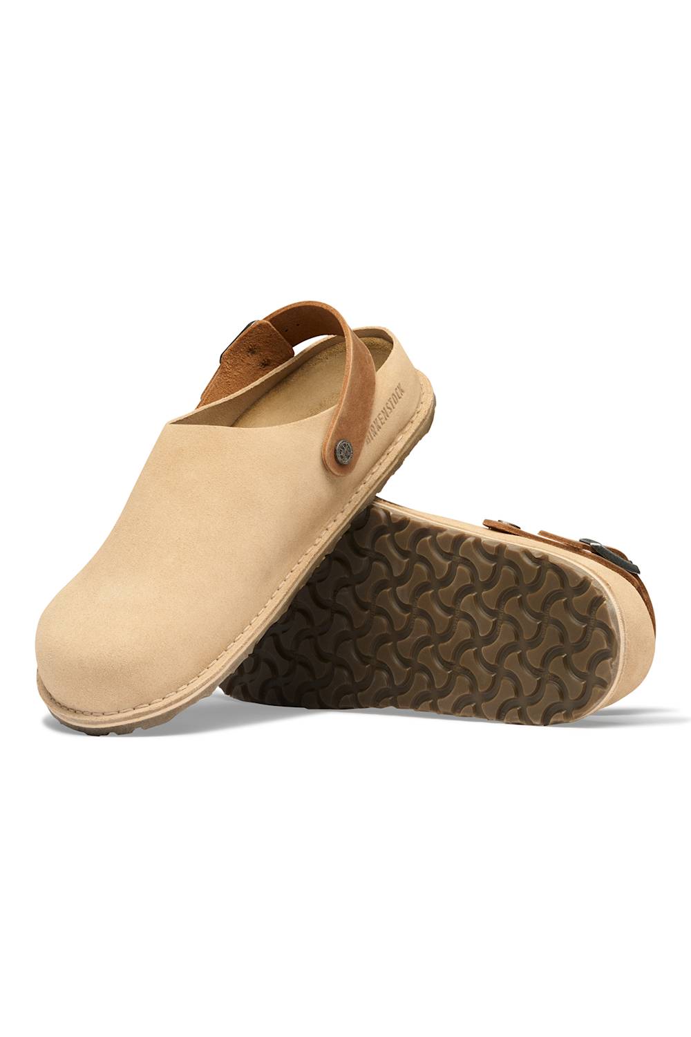A pair of beige suede clogs with brown straps and a dark brown textured outsole, shown on a clean white background.