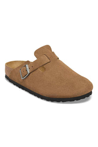 A tan suede clog-style mule shoe with a single strap and silver buckle, shown from a three-quarters angle on a white background.