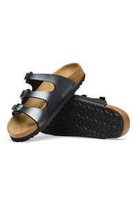 A pair of Birkenstock Arizona slide sandals in black with natural cork footbeds and soles, shown on a clean white background.