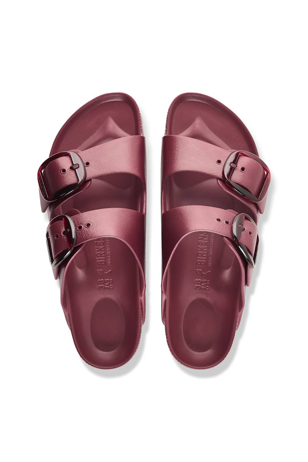 A pair of metallic rose gold double-strap slide sandals with silver-tone buckles, shown from a top-down view on a white background.