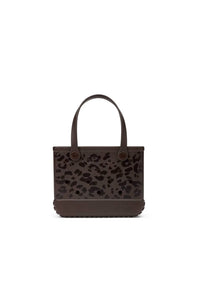 A dark brown leather tote bag with a leopard print pattern on the front and solid dark brown handles, shown against a plain white background.