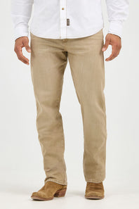 A person wearing beige straight-leg jeans, a white button-down shirt, and brown suede boots, shown from the waist down against a plain white studio background.