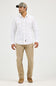 A man modeling a white long-sleeve western-style button-up shirt with embroidered chest pockets, paired with khaki pants, brown boots, and a gray baseball cap against a plain light gray studio background.