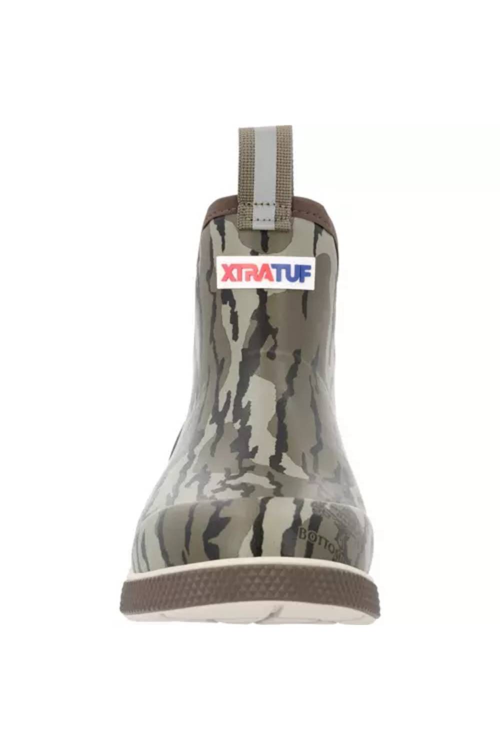 A single Xtratuf rubber rain boot shown from the back, featuring a camouflage pattern in shades of gray, brown, and green, with a white and gray pull tab and a red and blue Xtratuf logo on the back collar.