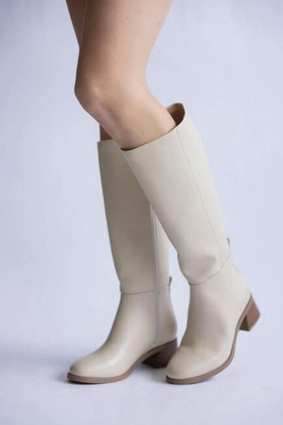 Beige knee-high boots on a light gray background.
