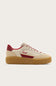A low-top platform sneaker by Soul, featuring a cream-colored upper with red accents, red laces, and a thick brown gum sole, shown against a light beige background.