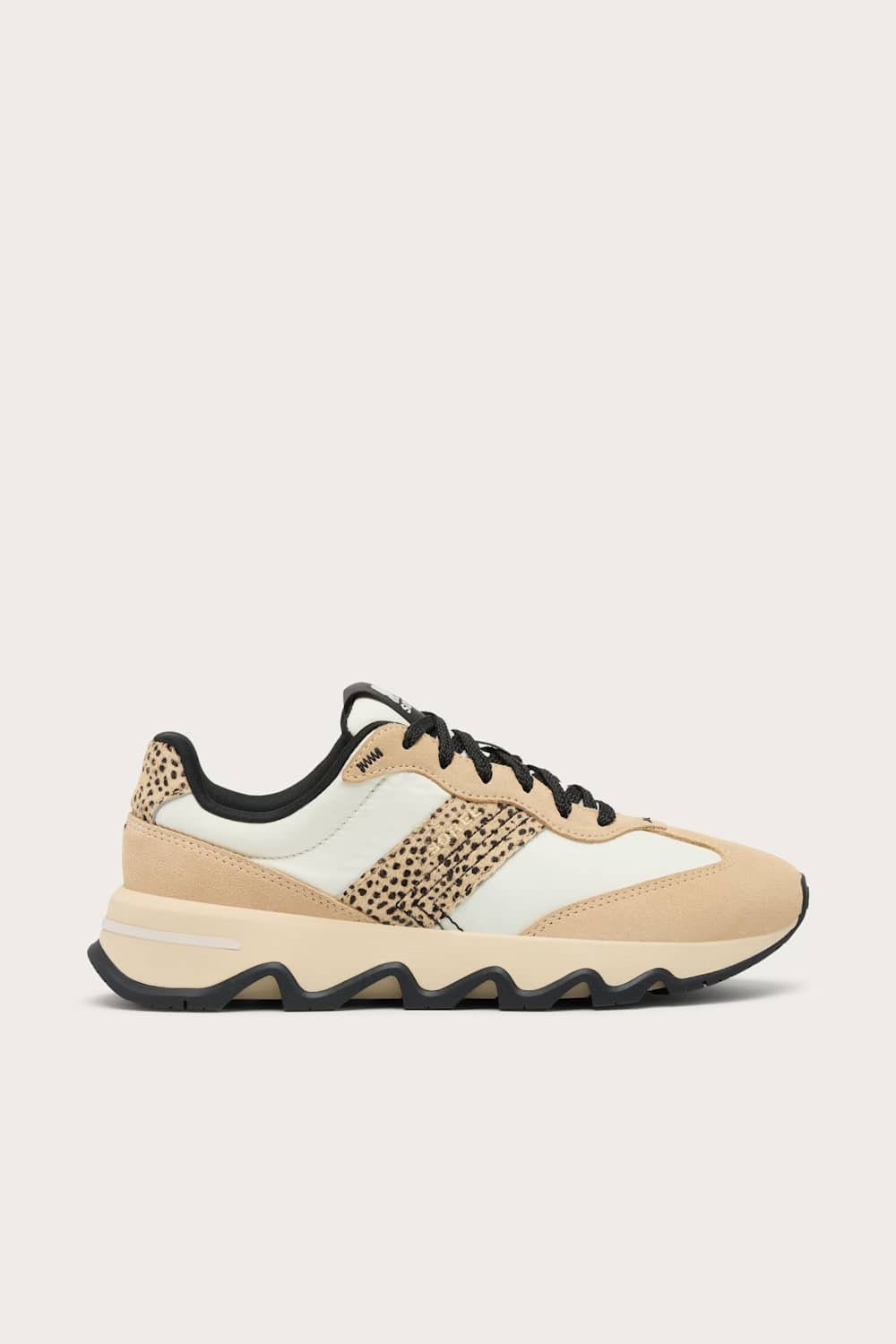 A low-top sneaker in beige and off-white with a leopard-print side panel and black laces, shown in a side profile on a light beige background.