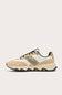 A low-top sneaker in beige and off-white suede and mesh, featuring a leopard-print pattern panel on the side and black laces, shown against a light beige background.