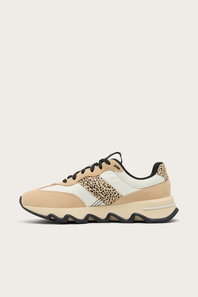 A low-top sneaker in beige and off-white suede and mesh, featuring a leopard-print pattern panel on the side and black laces, shown against a light beige background.