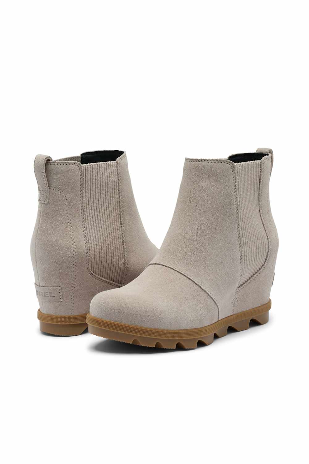A pair of women's ankle boots in a light taupe suede and ribbed fabric, featuring wedge heels and lug soles, shown against a plain white background.