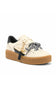 A low-top platform sneaker in off-white leather with a thick brown gum sole, a black heel tab, a black-and-white leopard print ribbon tied around the laces, and gold-tone hardware.