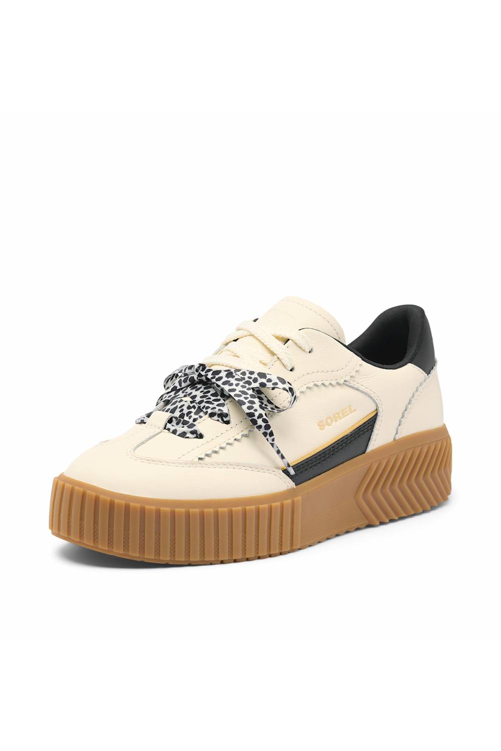 A low-top platform sneaker in cream and black with a brown gum sole and patterned laces, shown on a plain white background.