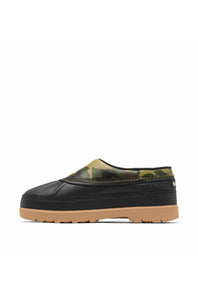 A single slip-on mule shoe shown in profile against a plain white background. The shoe has a black rubber toe cap and sole, a tan gum sole, and a black, olive green, and tan camouflage patterned upper.