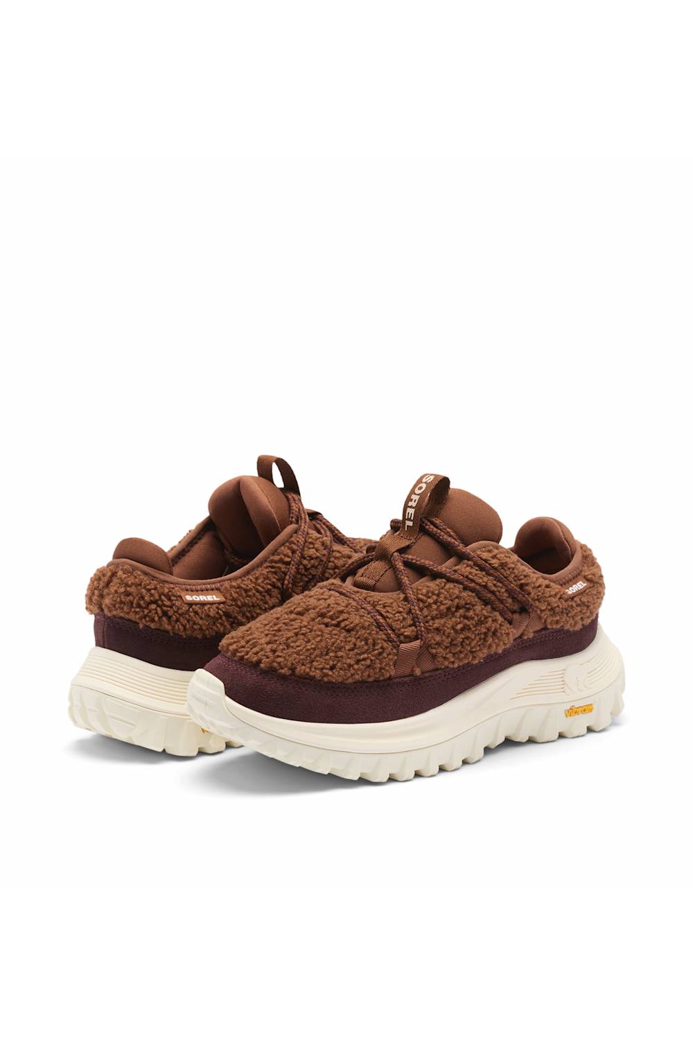 A pair of brown textured sneakers with thick cream-colored soles, displayed against a clean white background.