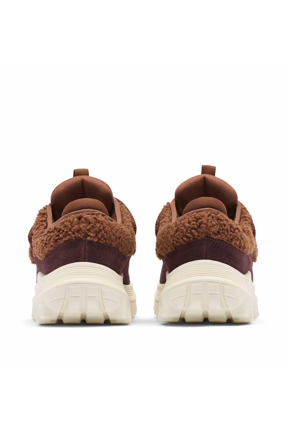 A pair of brown and burgundy fuzzy knit sneakers shown from the back, featuring thick cream-colored chunky soles, set against a plain white background.