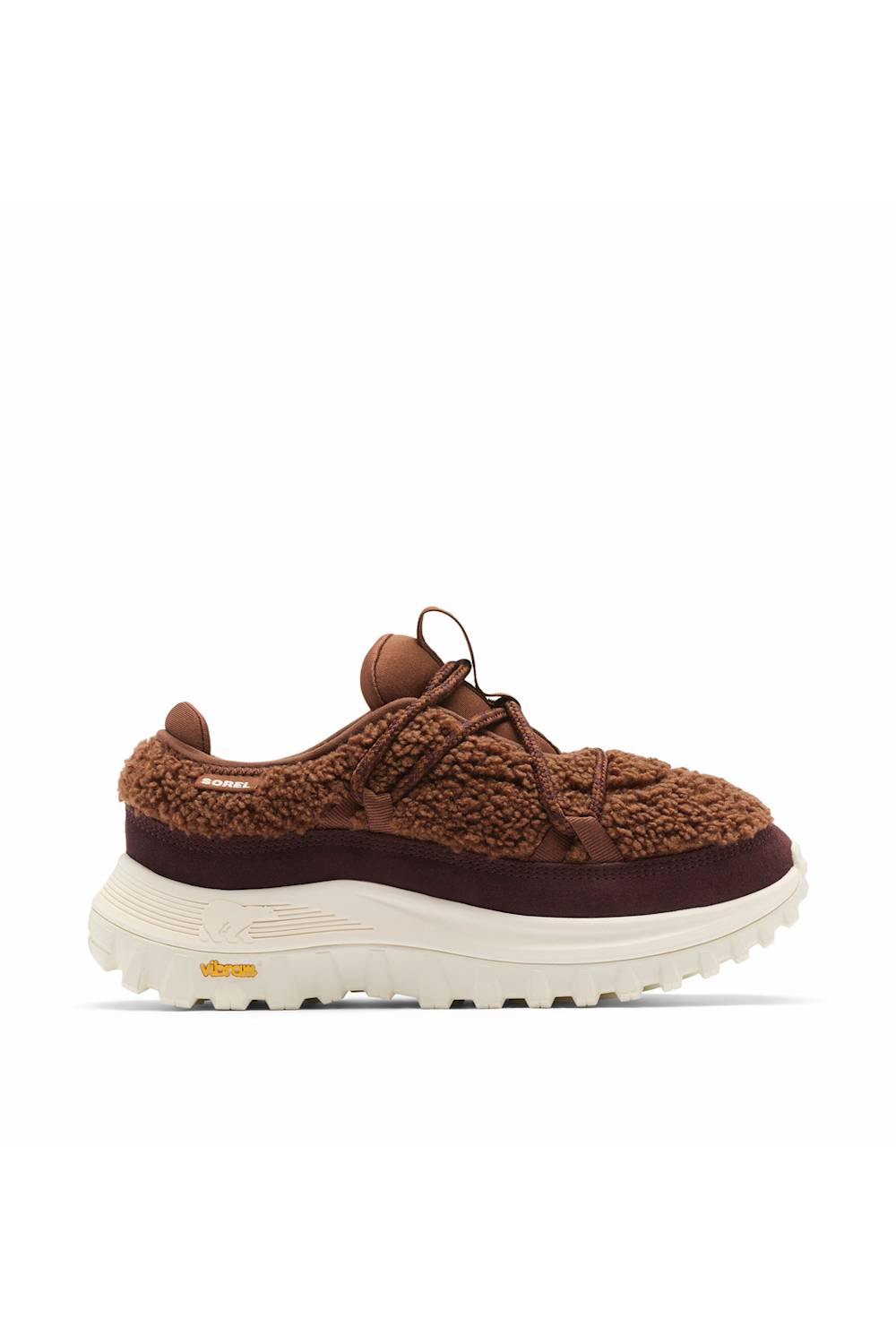 A brown knit and suede sneaker with a thick white Vibram sole, shown from the side on a white background.