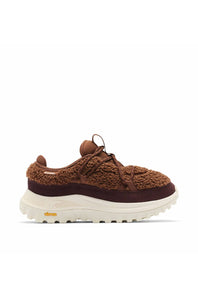 A brown knit and suede sneaker with a thick white Vibram sole, shown from the side on a white background.