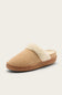 A single slip-on mule slipper in beige suede with a cream-colored faux shearling collar and a brown sole, shown against a light beige background.