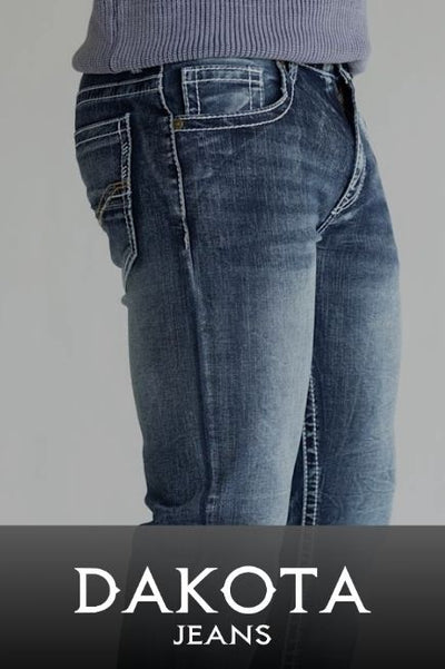A promotional image of a person wearing dark was jeans on a basic background with a black banner at the bottom with text DAKOTA JEANS