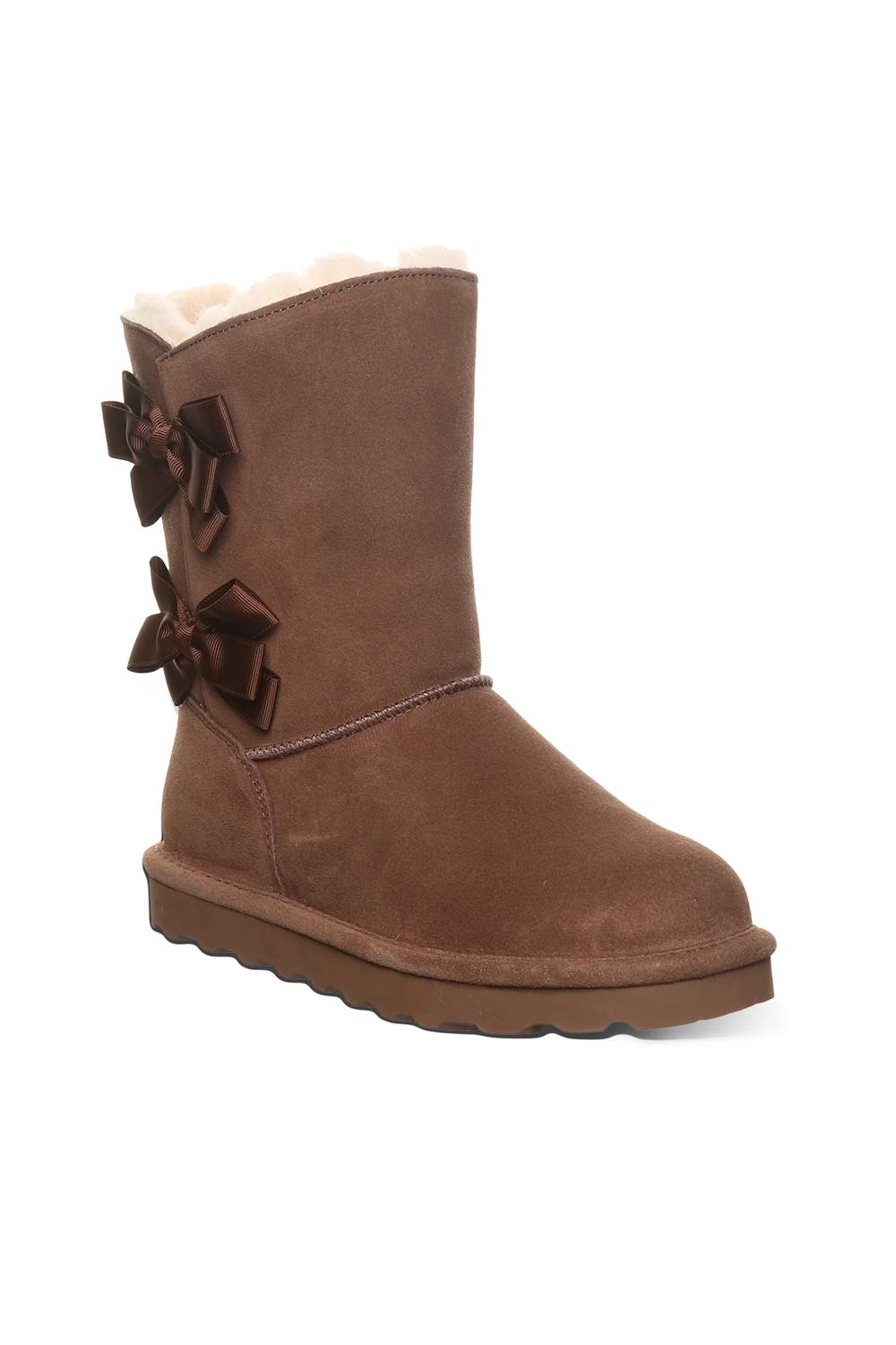 A brown suede ankle boot with decorative dark brown bows on the side and a soft cream-colored shearling lining visible at the top, set against a plain white background.