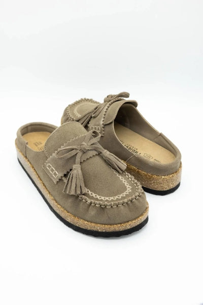 A pair of Moccasin style mules on a white background