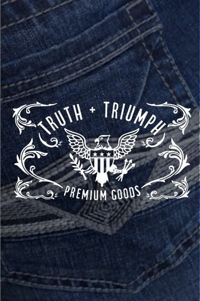 Dark image of a jeans back pocket with the TRUTH + TRIUMPH PREMIUM GOODS and eagle with a shield, arrows & branch in white over top