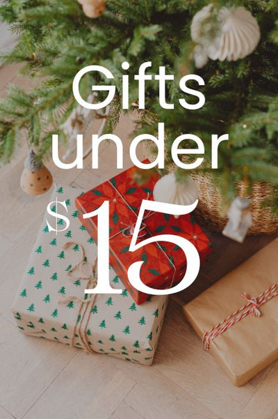 Gifts under $15 with a Christmas tree in the background