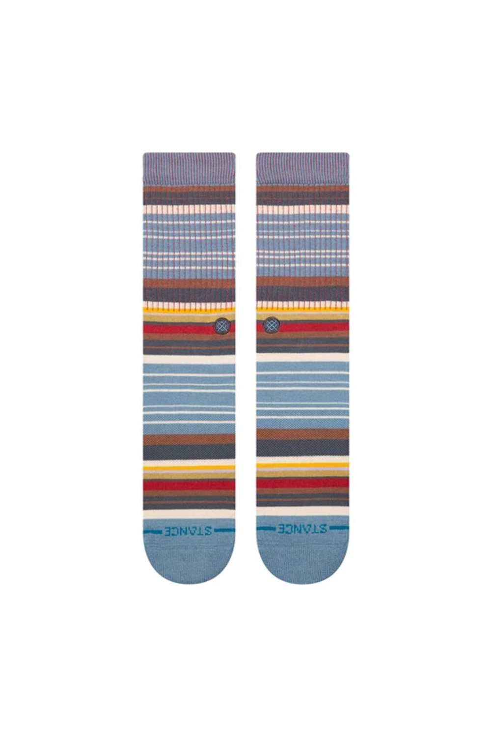 A pair of Stance crew socks with a multicolor striped pattern in shades of blue, brown, red, yellow, and white, featuring the Stance brand name on the toes.