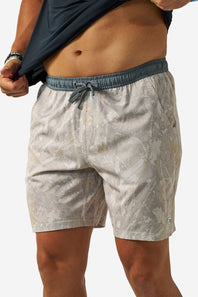 Men's athletic shorts with a light gray and beige camouflage pattern, featuring a slate grey elastic waistband and drawstring, modeled on a person against a white background.