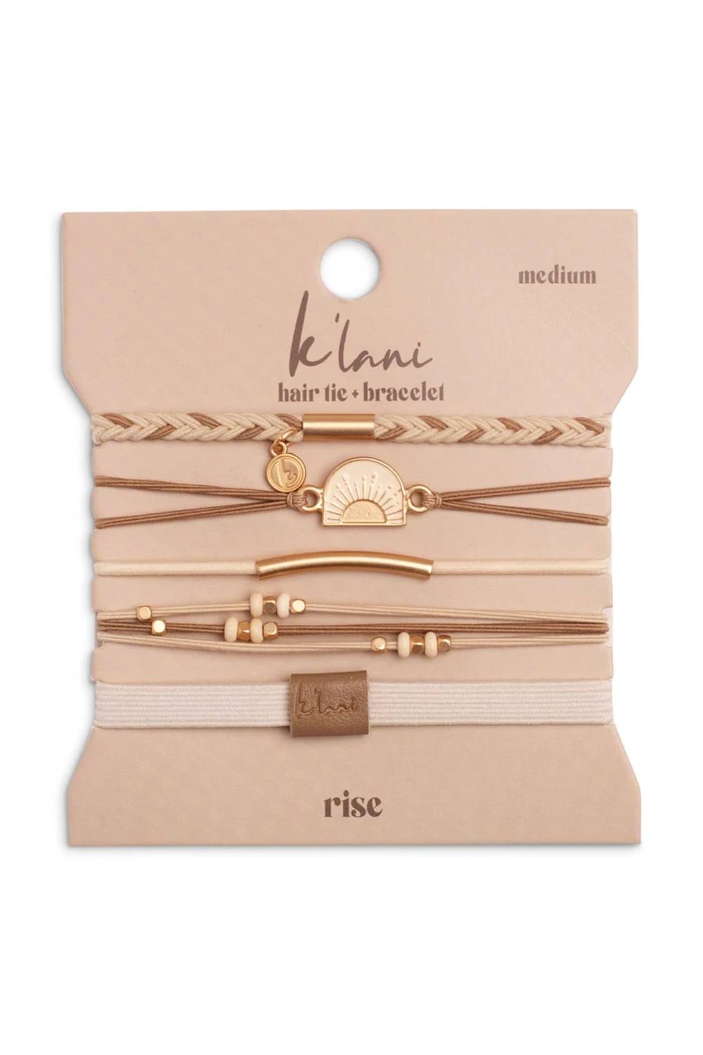A 5-piece hair tie and bracelet set by K'lan'i in the 'rise' colorway, displayed on its beige cardboard backing card. The set includes elastic hair ties and braided/cord bracelets in shades of beige, tan, and light brown, accented with gold-tone metal charms, beads, and a small crescent moon charm.
