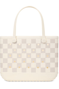 A light beige and off-white checkered tote bag with small gold polka dots and cream-colored shoulder straps, shown against a plain white background.
