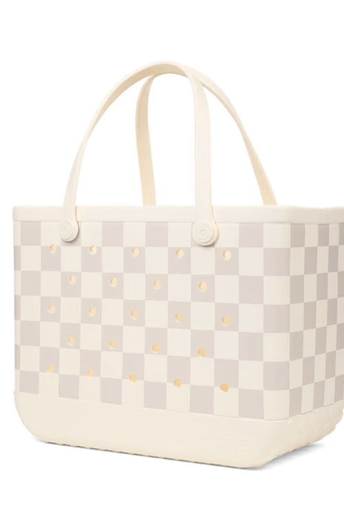 A structured tote bag featuring a cream and light beige checkerboard pattern with small gold studs, cream handles, and a cream base, shown on a plain white background.